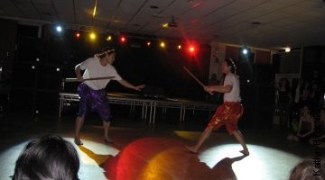 Thailand Society perform a dance and swordfight.