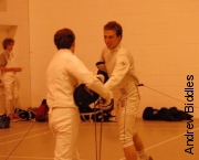 Denniss shakes hands after epee bout